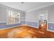 Bright dining room with hardwood floors, pendant lighting, and an open view into the living area at 504 Crooked Pine Dr, Cary, NC 27519