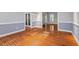 Dining room with hardwood floors, wainscoting, and glass doors leading to additional living spaces at 504 Crooked Pine Dr, Cary, NC 27519