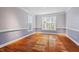 Sunlit dining room featuring hardwood floors, wainscoting, and large windows with outdoor views at 504 Crooked Pine Dr, Cary, NC 27519