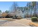Suburban home featuring a two-car garage and a long driveway with mature landscaping on a sunny day at 504 Crooked Pine Dr, Cary, NC 27519