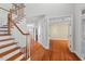 Elegant foyer features hardwood floors, staircase with wood railing, and open rooms at 504 Crooked Pine Dr, Cary, NC 27519