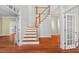Elegant foyer features hardwood floors, staircase with wood railing, and french doors at 504 Crooked Pine Dr, Cary, NC 27519
