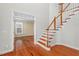 Elegant foyer features hardwood floors, staircase with wood railing, and open rooms at 504 Crooked Pine Dr, Cary, NC 27519