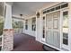 Inviting front porch with brick details, a painted column, and a stylish gray front door at 504 Crooked Pine Dr, Cary, NC 27519