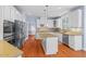 Spacious kitchen with stainless steel appliances, center island and light wood flooring at 504 Crooked Pine Dr, Cary, NC 27519