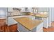 Close-up of kitchen island featuring granite counter tops and stainless steel appliances at 504 Crooked Pine Dr, Cary, NC 27519