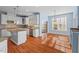 Modern kitchen featuring white cabinets, stainless steel appliances, and an adjacent dining area at 504 Crooked Pine Dr, Cary, NC 27519