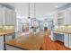 Modern kitchen flowing into the open concept living room with a fireplace and light-filled windows at 504 Crooked Pine Dr, Cary, NC 27519