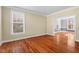 Bright living room with hardwood floors, large windows, and neutral wall paint at 504 Crooked Pine Dr, Cary, NC 27519