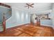 Spacious living room featuring hardwood floors, access to the kitchen, and staircase at 504 Crooked Pine Dr, Cary, NC 27519