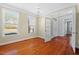 Bright living room with hardwood floors, large windows, and French doors at 504 Crooked Pine Dr, Cary, NC 27519
