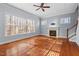 Cozy living room with large windows, a fireplace, hardwood floors, and a staircase at 504 Crooked Pine Dr, Cary, NC 27519