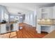 Open concept living room area with wet bar, fireplace, and staircase with hardwood flooring at 504 Crooked Pine Dr, Cary, NC 27519