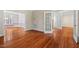 Spacious living room with hardwood floors, multiple doorways, and neutral wall paint at 504 Crooked Pine Dr, Cary, NC 27519