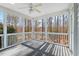 Cozy screened-in sunroom with ceiling fan and backyard view at 504 Crooked Pine Dr, Cary, NC 27519
