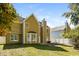 A well-maintained backyard features a grassy lawn, mature trees, and a charming home exterior at 5129 Chasteal Trl, Raleigh, NC 27610