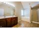 Bright bathroom with double sink vanity, soaking tub, and glass shower at 5129 Chasteal Trl, Raleigh, NC 27610