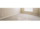 Neutral carpeted bedroom features a large window and base trim molding at 5129 Chasteal Trl, Raleigh, NC 27610