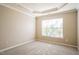 Bedroom with tray ceiling and large window with natural light shining through at 5129 Chasteal Trl, Raleigh, NC 27610