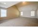 Vaulted ceiling bedroom offers three large windows and soft neutral carpet at 5129 Chasteal Trl, Raleigh, NC 27610