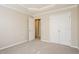 Bedroom with closet and door to another room, with neutral colors and carpet at 5129 Chasteal Trl, Raleigh, NC 27610