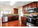 Kitchen boasting stainless steel appliances, dark wood cabinets, and an open layout at 5129 Chasteal Trl, Raleigh, NC 27610