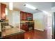 Kitchen featuring stainless steel appliances, cherry cabinets, and granite countertops at 5129 Chasteal Trl, Raleigh, NC 27610