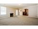 Inviting living room with fireplace, neutral carpet, and open view to the kitchen at 5129 Chasteal Trl, Raleigh, NC 27610