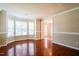 Bright living room with hardwood floors, large bay windows, and an open layout at 5129 Chasteal Trl, Raleigh, NC 27610