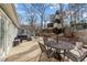 Wood back deck with wrought iron table and umbrella plus outdoor seating furniture at 5412 Farley Dr, Raleigh, NC 27609