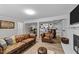 Finished basement area featuring a leather couch, fireplace, desk, and bar area with wood accents at 5412 Farley Dr, Raleigh, NC 27609