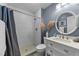Modern bathroom features a tile shower, updated vanity, and decorative accents at 5412 Farley Dr, Raleigh, NC 27609