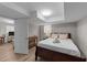 Basement bedroom with a large bed, side table, and closet near the doorway with neutral colors at 5412 Farley Dr, Raleigh, NC 27609
