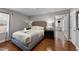 Comfortable bedroom features a king-size bed, hardwood floors, and an ensuite bathroom at 5412 Farley Dr, Raleigh, NC 27609