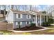 Charming gray two-story home featuring white shutters, landscaped yard and inviting columned front porch at 5412 Farley Dr, Raleigh, NC 27609