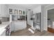 Bright kitchen with stainless steel refrigerator, white cabinets, and view to dining room at 5412 Farley Dr, Raleigh, NC 27609