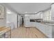 Bright kitchen with white cabinets, modern appliances, and laundry area with lots of room at 5412 Farley Dr, Raleigh, NC 27609