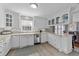 Well-lit kitchen with white cabinets, stainless steel appliances, and a view into the dining area at 5412 Farley Dr, Raleigh, NC 27609