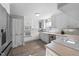 Bright kitchen with stainless steel appliances and white cabinets, with wood look floors at 5412 Farley Dr, Raleigh, NC 27609