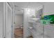 Organized laundry room with shelves and storage space plus access to a convenient half bathroom at 5412 Farley Dr, Raleigh, NC 27609