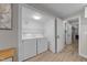 Laundry room with white washer and dryer, white cabinets with new flooring and modern paint at 5412 Farley Dr, Raleigh, NC 27609
