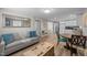 Comfortable living and dining area with modern flooring, a couch, table, and kitchen in the background at 5412 Farley Dr, Raleigh, NC 27609