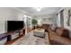 Cozy living room featuring hardwood floors, a large sectional sofa, and modern decor at 5412 Farley Dr, Raleigh, NC 27609