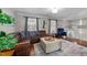 Inviting living room with hardwood floors, comfortable seating, and ample natural light from the large windows at 5412 Farley Dr, Raleigh, NC 27609