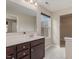 Bathroom boasting a double sink vanity, a large mirror, and a window for natural light at 5439 Ripplebrook Rd, Durham, NC 27712