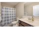 Cozy bathroom featuring a blue plaid shower curtain, a toilet, and vanity with sink at 5439 Ripplebrook Rd, Durham, NC 27712