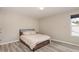 Bedroom features a bed, a window, and vinyl plank flooring, offering a cozy and modern space at 5439 Ripplebrook Rd, Durham, NC 27712