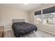 Bedroom with vinyl flooring, offering a view through windows and equipped with roller shades at 5439 Ripplebrook Rd, Durham, NC 27712