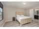 Comfortable bedroom with a light-colored wood flooring, a bed and an attached bathroom at 5439 Ripplebrook Rd, Durham, NC 27712