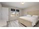 Bright bedroom featuring a neutral color scheme, two windows and light-colored wood flooring at 5439 Ripplebrook Rd, Durham, NC 27712